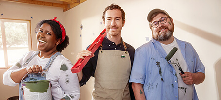 Image of 3 happy people getting ready to paint